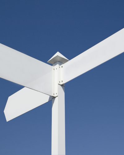 White sign with three arrows pointing in different directions